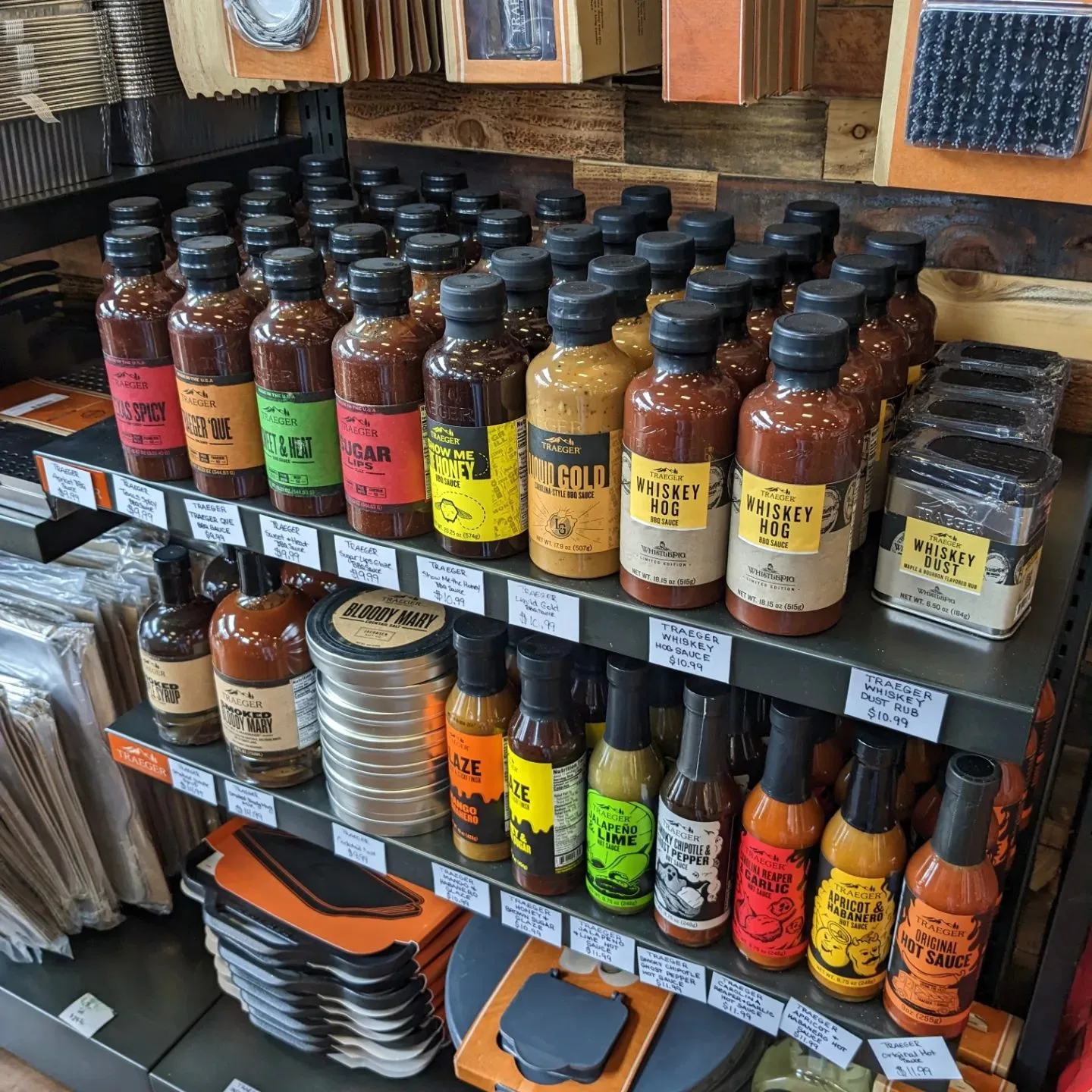 Shelves of Traeger sauces, rubs, and grilling accessories inside Falco's showroom